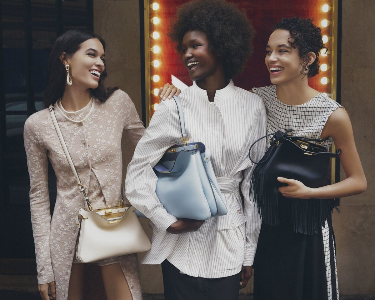 Models posing with Fendi handbags for an editorial photoshoot