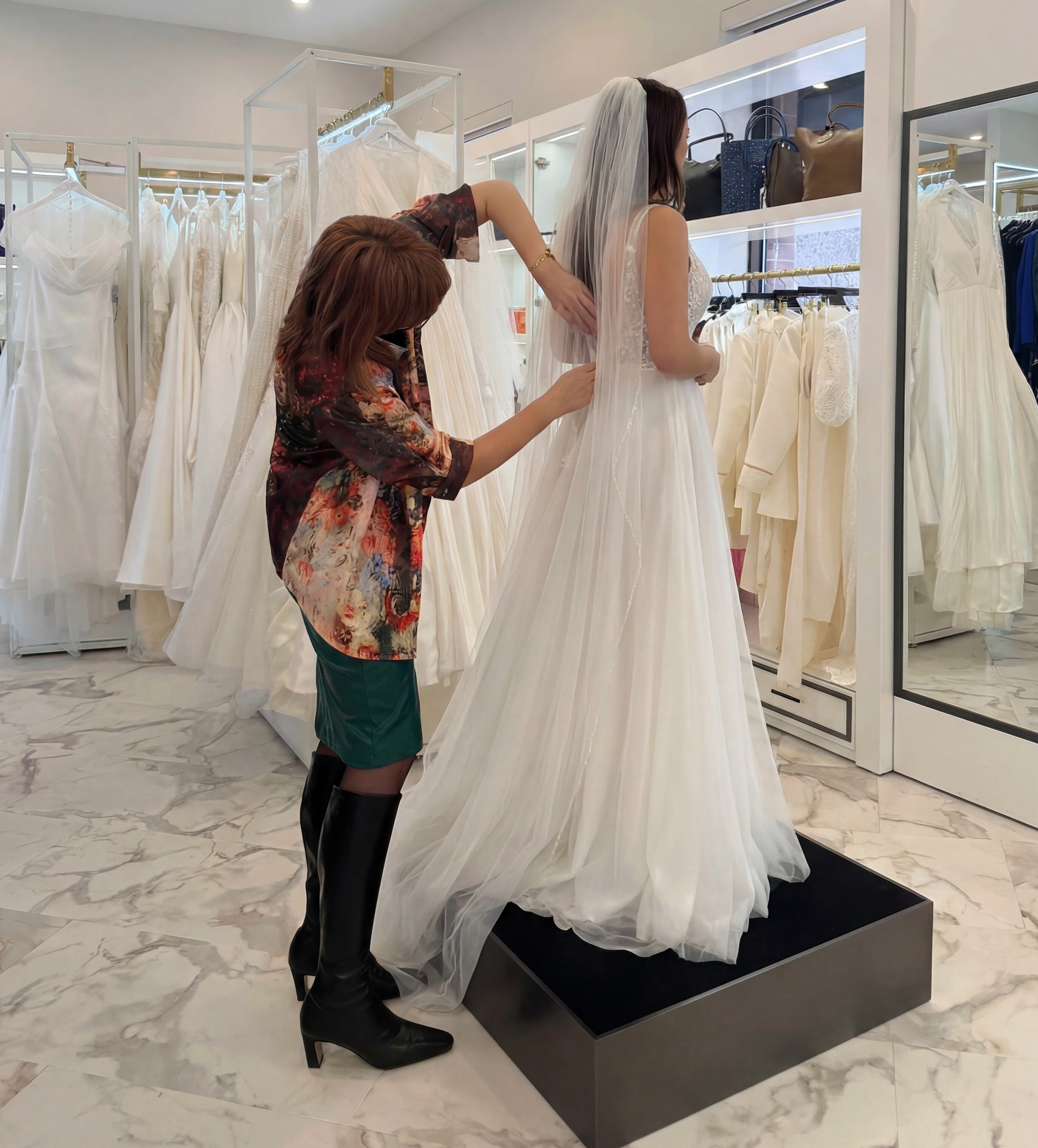 A tailor adjusting a fitting on a bride