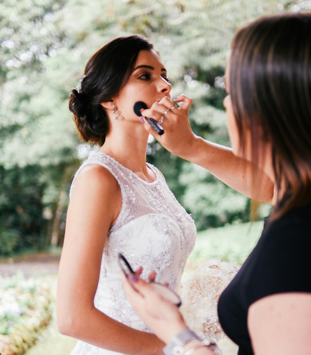 a bride having her makeup retouched