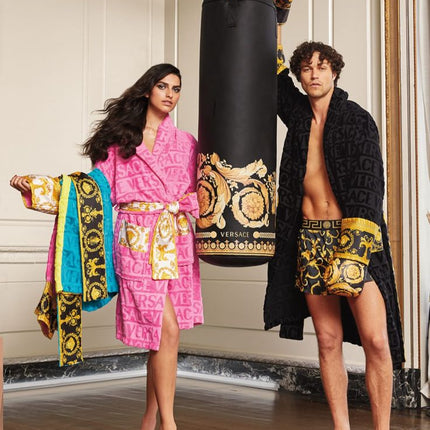 man and woman wearing Versace robes