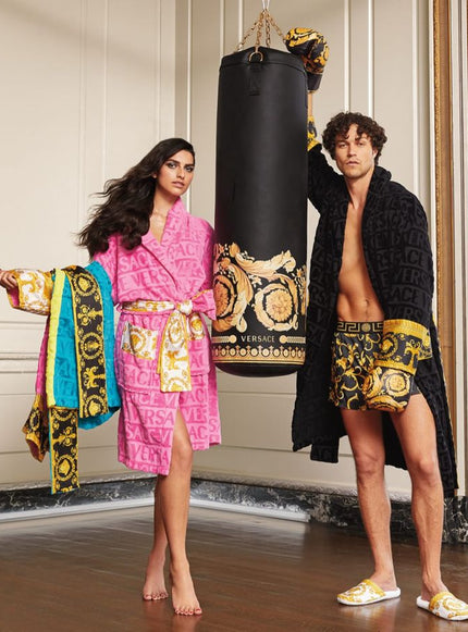 man and woman wearing Versace robes