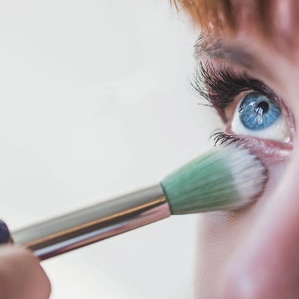 Model applying eye makeup