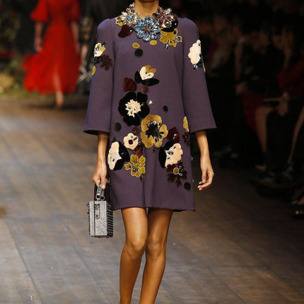 Woman walking down runway in Dolce & Gabbana dress