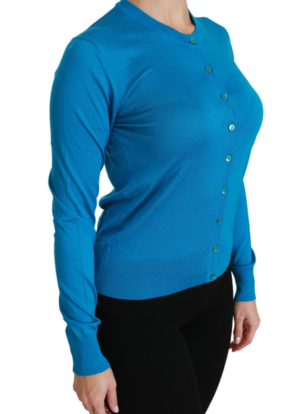 a woman wearing a blue sweater and black pants