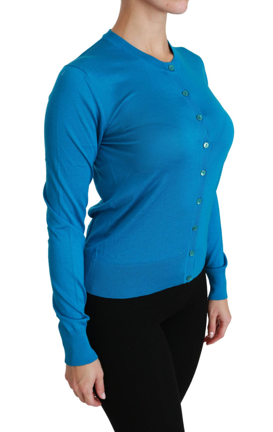 a woman wearing a blue sweater and black pants