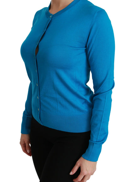 a woman in a blue shirt and black pants