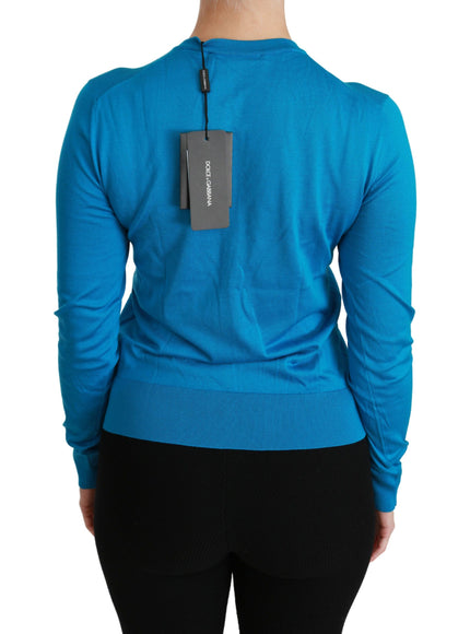 a woman wearing a blue sweater with a tag on it