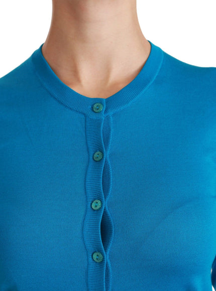 a woman wearing a blue cardigan with buttons