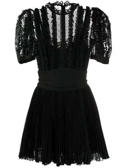 a black dress with sheer sleeves and a pleaed skirt