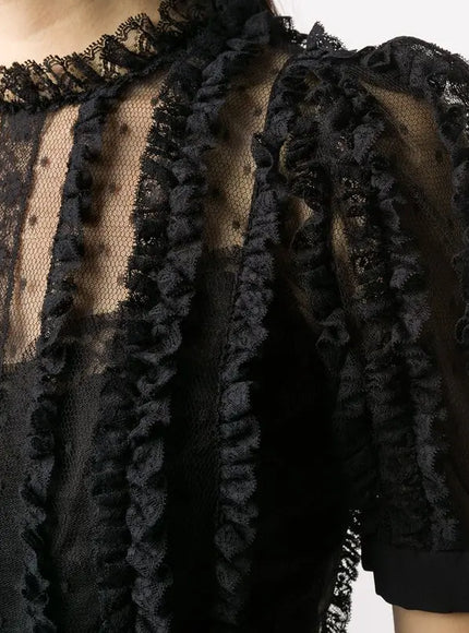 a close up of a woman wearing a black dress