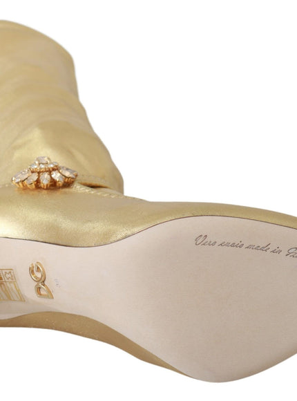 a gold high heeled shoe with a diamond brooch