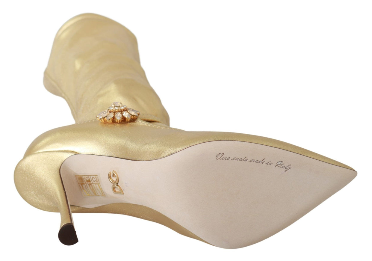 a gold high heeled shoe with a diamond brooch