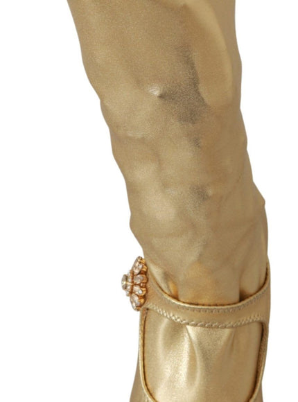 a pair of gold boots with a white background