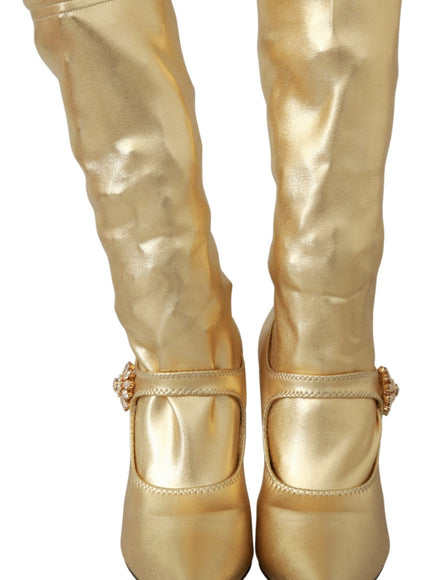 a pair of gold boots with buckles