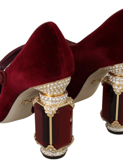 a pair of red high heeled shoes with gold chains