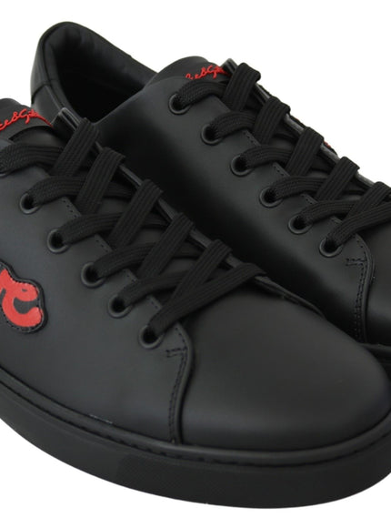 a pair of black sneakers with red lettering