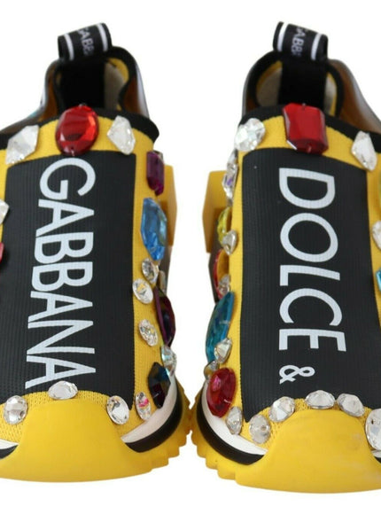 a pair of yellow shoes with colorful stones on them