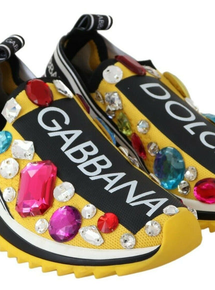 a pair of yellow shoes with colorful stones on them