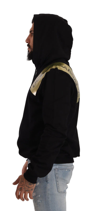 a man wearing a black hoodie with a gold stripe