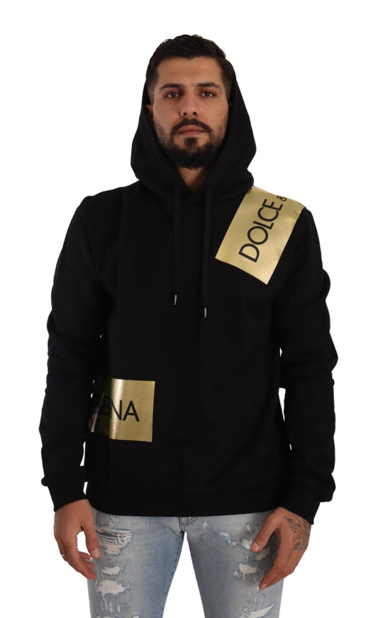 a man wearing a black and gold hoodie