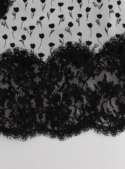 a piece of black lace with flowers on it