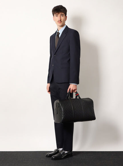 Gucci Coated Canvas Gg Emblem Travel Bag With Gg Motif