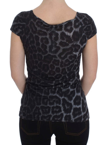 a woman wearing a black top with a leopard print