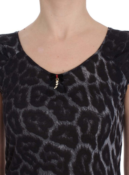 a woman wearing a black top with a leopard print pattern