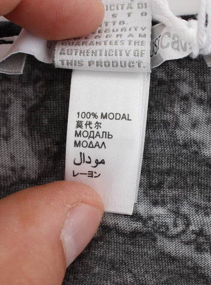 a close up of a person holding a label on a piece of clothing