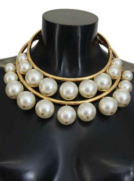 a mannequin wearing a necklace with pearls