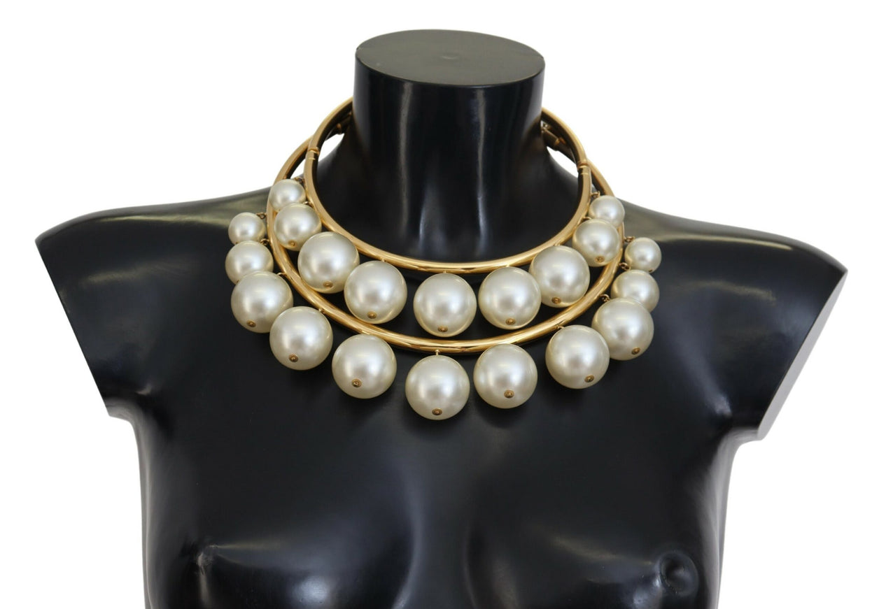 a mannequin wearing a necklace with pearls