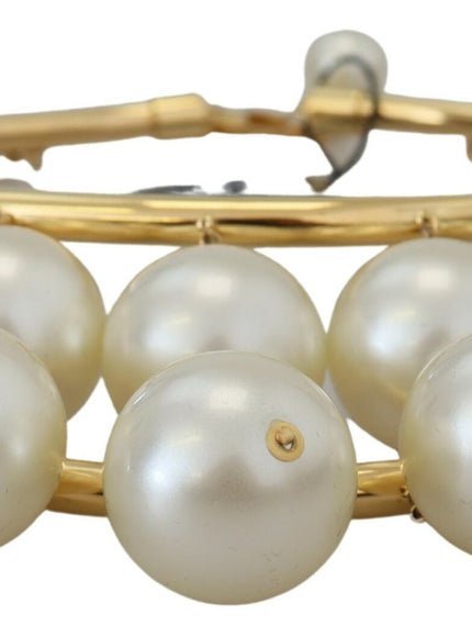 a bunch of white pearls on a gold ring