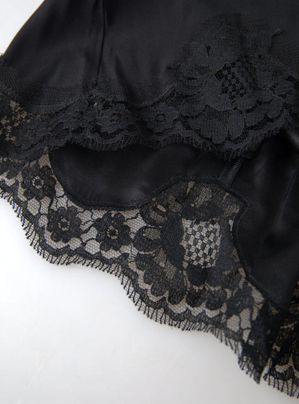 a close up of a black dress on a white surface