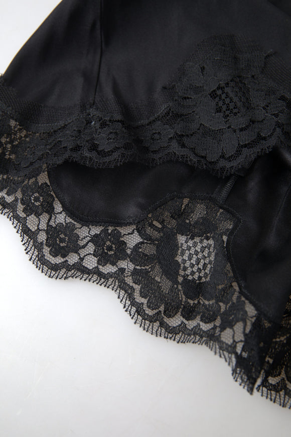 a close up of a black dress on a white surface