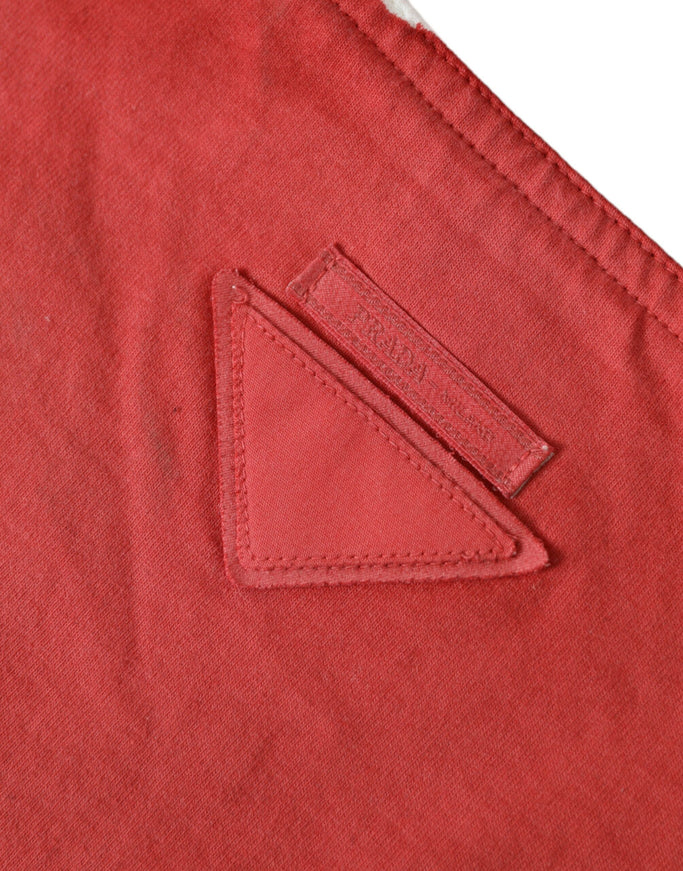 a close up of a red shirt with a patch on it