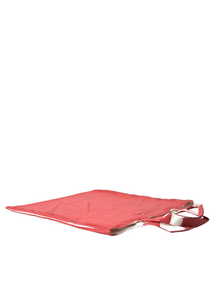 a red cloth with a silver handle on a white background