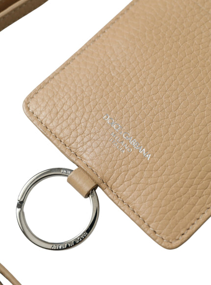 a tan purse with a key chain attached to it