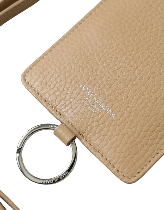 a tan purse with a key chain attached to it