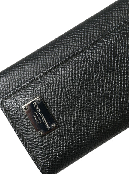 a black leather wallet with a tag on it