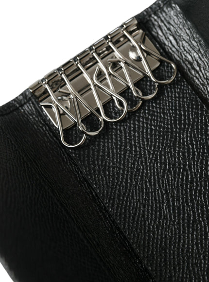 a close up of a black purse with a metal clip