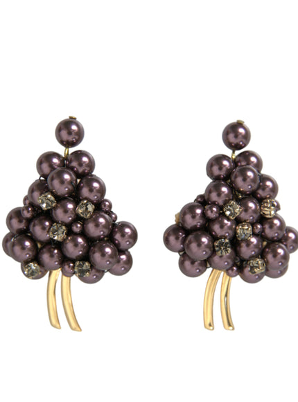 a pair of earrings with pearls on them