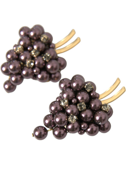 a pair of earrings with pearls and gold