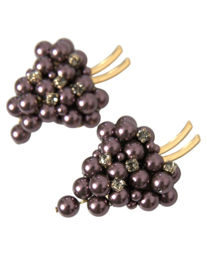 a pair of earrings with pearls and gold