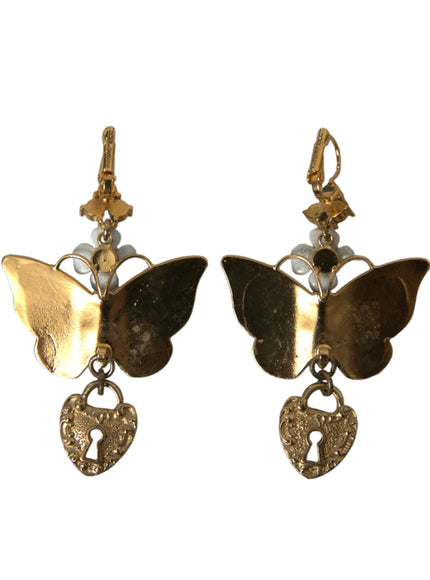 a pair of earrings with a butterfly and a heart