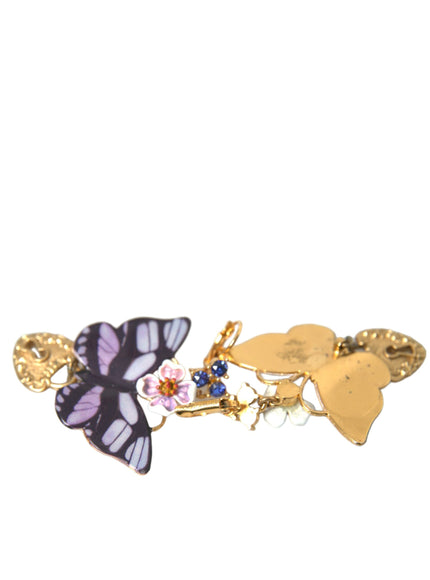 a close up of a brooch with a butterfly on it