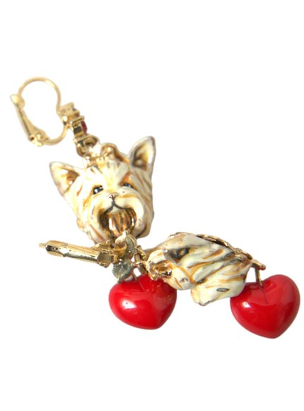 a pair of earrings with a cat and two cherries