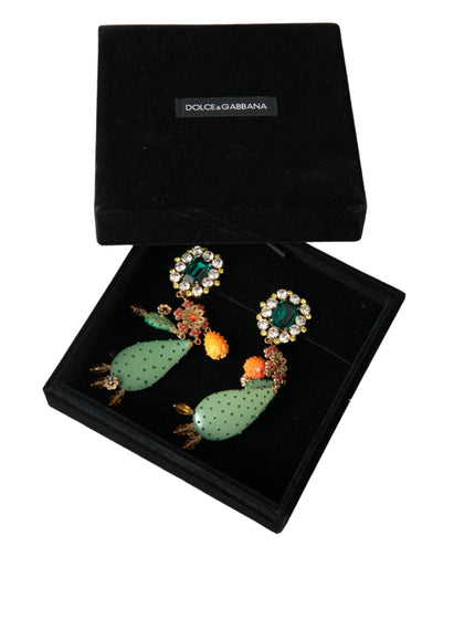 a pair of earrings in a box on a white background