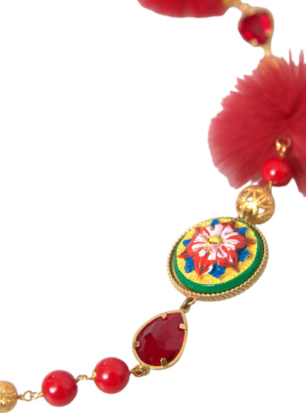 a necklace with red beads and a red flower