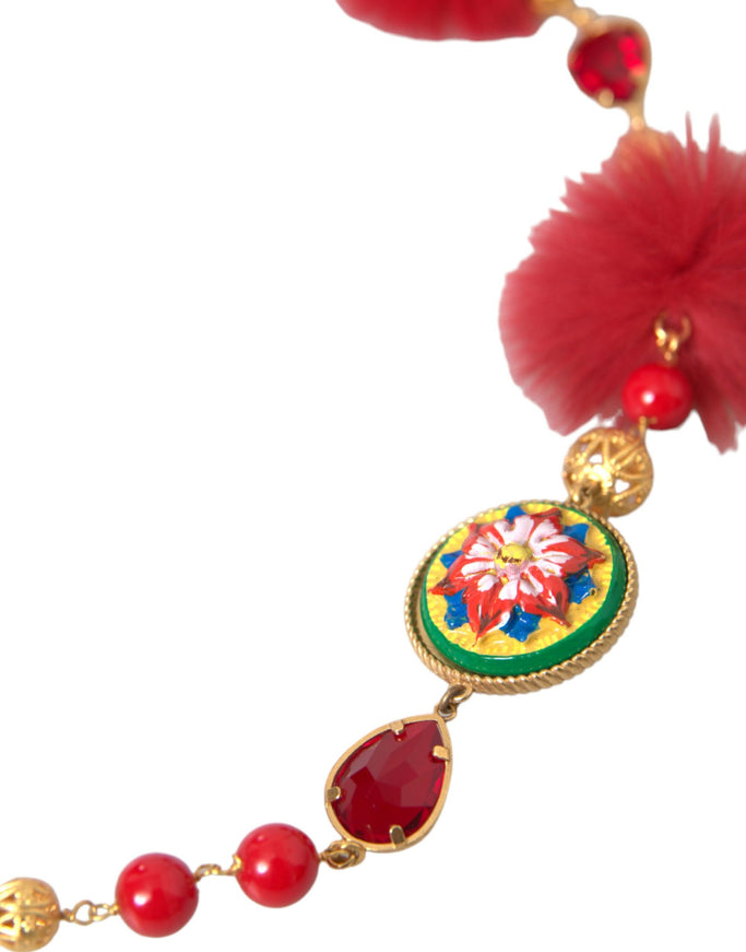 a necklace with red beads and a red flower