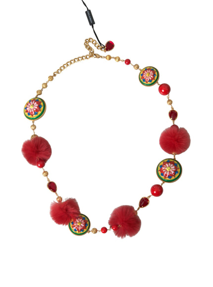 a necklace with red beads and pom poms